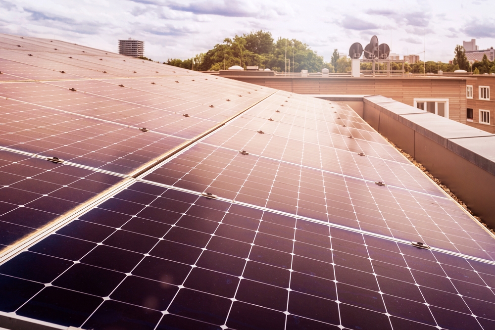 Solar,Panel,Roof,Building,On,Skyscrapers,Background,With,Sun,Reflection.