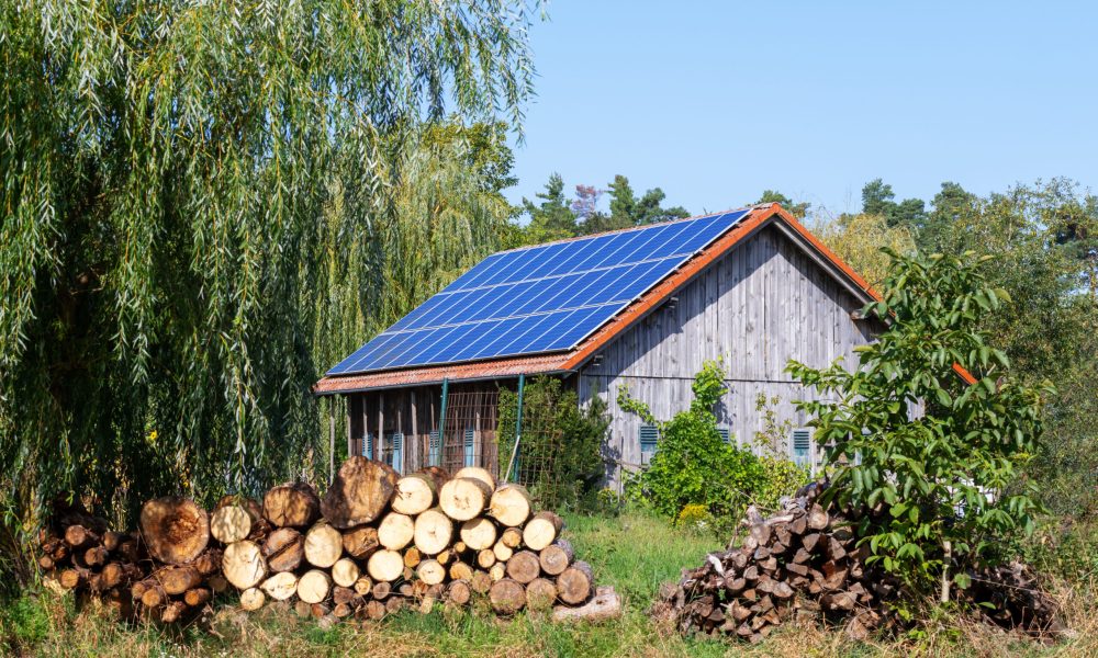 Green energy with solar collectors on the roof of an agricultural building